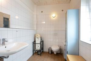 a bathroom with a sink and a toilet at Seminarhof Mollandur in Bochow +63 photos