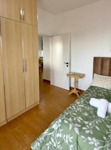 a bedroom with a bed and a closet and a door at VILA ELEZI Piqeras in Borsh +41 photos