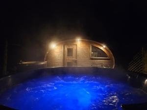 a large blue bath tub in front of a building at Villa nad Kalwą in Tylkowo