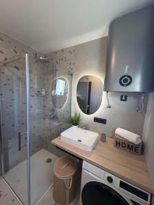 a bathroom with a sink and a shower at Maris Loft Šimuni in Šimuni +48 photos