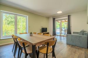 a dining room with a wooden table and chairs at Ubytování U Lesíka in Znojmo