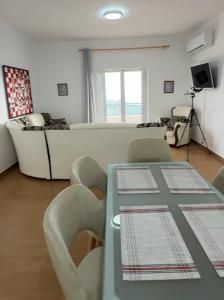 a living room with a table and a couch at VILA ELEZI Piqeras in Borsh