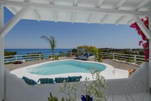 a swimming pool with a view of the ocean at Endless Horizon At Stegna in Archangelos