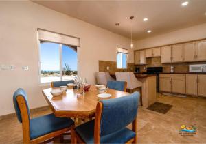 a kitchen and dining room with a wooden table and chairs at Casa Desert Rose - Gated Community San Felipe Vacation Rental Home in Playa Hawaii