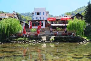 a restaurant next to a body of water at Motel Alibi in Banja Luka