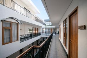 an empty corridor of a building with balconies at Dhipa Kinanthi Prawirotaman by Raminten in Timuran