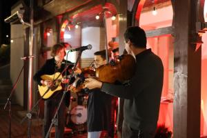 a group of people singing and playing instruments in a room at Sándor János Villa in Sovata
