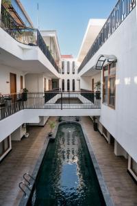 a house with a pond in the middle of it at Dhipa Kinanthi Prawirotaman by Raminten in Timuran