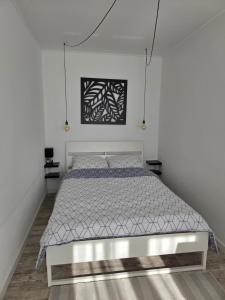 a bedroom with a bed in a white room at Apartamenty Nowielice in Nowielice