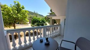 a balcony with a table and a view of a street at NESTOR LUXURY Studios in Vathi
