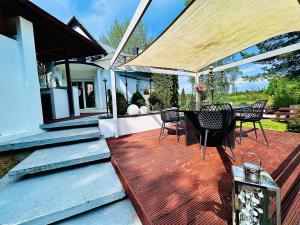 a deck with a table and chairs on a house at Dora Design House in Człuchów