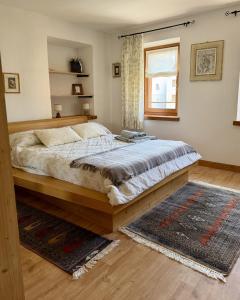 a bedroom with a large bed and a window at Casa Borgovillanuova in Laggio