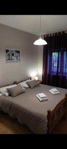 a bedroom with a large bed with towels on it at Agrotourism Galic Krka in Drinovci +37 photos
