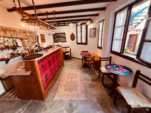 a bar in a restaurant with tables and chairs at KRIS Guest House in Berat