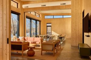 a living room with a lot of furniture and windows at AutoCamp Asheville in Asheville