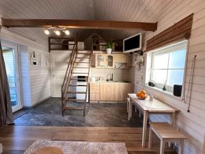 a kitchen with a staircase in a tiny house at Leia Kodu Private Garden House with Terrace & Parking in Rakvere in Rakvere