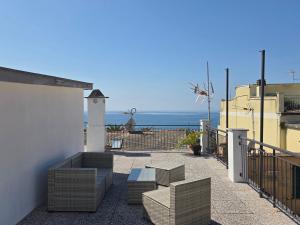 a balcony with benches and a view of the ocean at H H Moneglia il Vicolo in Moneglia