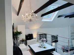 a living room with a chandelier and a table at Dora Design House in Człuchów