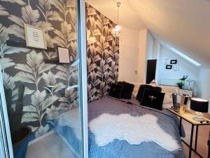 a bedroom with a bed with a wall at Dora Design House in Człuchów