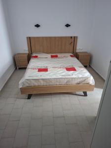 a bedroom with a bed with red cards on it at Mary Apartments in Stalís
