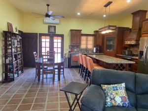 a kitchen with a couch and a table with chairs at Casa Serenidad familiar escapade in San Felipe