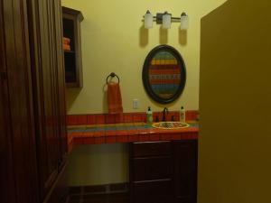 a bathroom with a sink and a mirror at Casa Serenidad familiar escapade in San Felipe +10 photos
