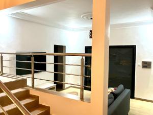 a living room with a staircase and a couch at Villa Keur Lune - Saly - SENEGAL in Saly Portudal