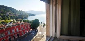 a view from a window of a building and a river at Sunset Suite in Laveno-Mombello