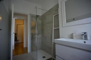 a bathroom with a glass shower and a sink at Sunset Suite in Laveno-Mombello