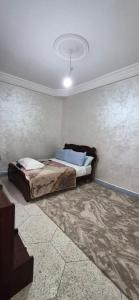 a bedroom with a bed and a ceiling at DowntownHouse in Midelt in Midelt