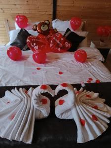 a bed with two swans made to look like hearts at Poienița Lupului in Vărbilău +114 photos