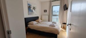 a bedroom with a bed with towels on it at Zeebrugge Sea View, Family-Friendly & the Beach! in Zeebrugge