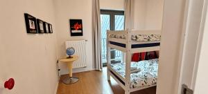 a small room with a bunk bed and a staircase at Zeebrugge Sea View, Family-Friendly & the Beach! in Zeebrugge