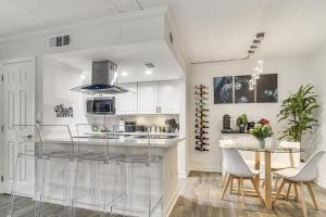 a kitchen with a glass counter and a table at < 2 Mi to Coast: St Pete Beach Gem w/ Pool Access in St. Pete Beach