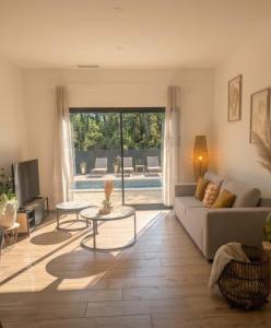 a living room with a couch and a table at Jardin de Sévigné à Grignan in Grignan
