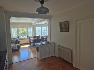 a living room with a table and a dining room at Charmig bottenvåning i Limhamn in Limhamn