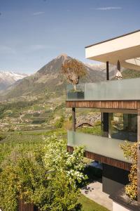 a house with a view of the mountains at View House - Chalet Goyen in Schenna