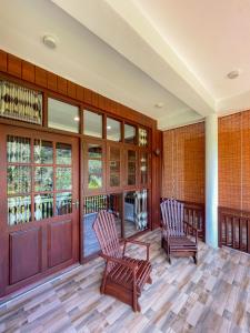 two chairs on the porch of a house at Hotel Levon Ella in Ella +23 photos