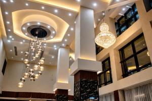 a lobby with a chandelier in a building at Delight Premium Hotel in Djibouti +17 photos