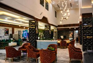 a restaurant with chairs and tables and a chandelier at Delight Premium Hotel in Djibouti