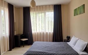 a bedroom with a bed in front of a window at Belogradchik View Apartment in Belogradchik
