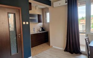 a kitchen with a door open to a kitchen with a window at Belogradchik View Apartment in Belogradchik