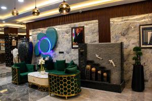 a lobby with green chairs and a fireplace at Delight Premium Hotel in Djibouti