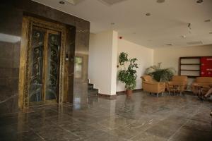 a lobby with a large door in a building at Masi Otel in Bademli