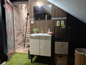 a bathroom with a white sink and a staircase at Cocon industriel pour Nuits étoilées in Bourges +8 photos