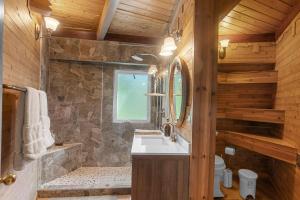 a bathroom with a sink and a stone shower at 9 Minute Drive to the Lake in Chelan +67 photos