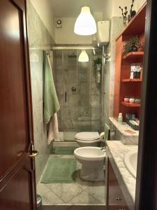 a bathroom with a shower and a toilet and a sink at Le Petite Maison in Andria