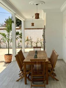 a wooden table and chairs on a patio at Villa Keur Lune - Saly - SENEGAL in Saly Portudal