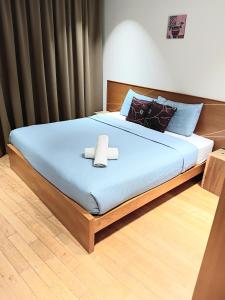 a bedroom with a bed with a cross on it at Vortex suites klcc by kl cozy home in Kuala Lumpur +38 photos