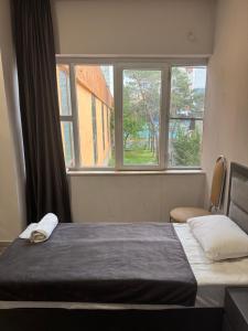 a bedroom with a bed and a window at The Corner Hotel in Yerevan